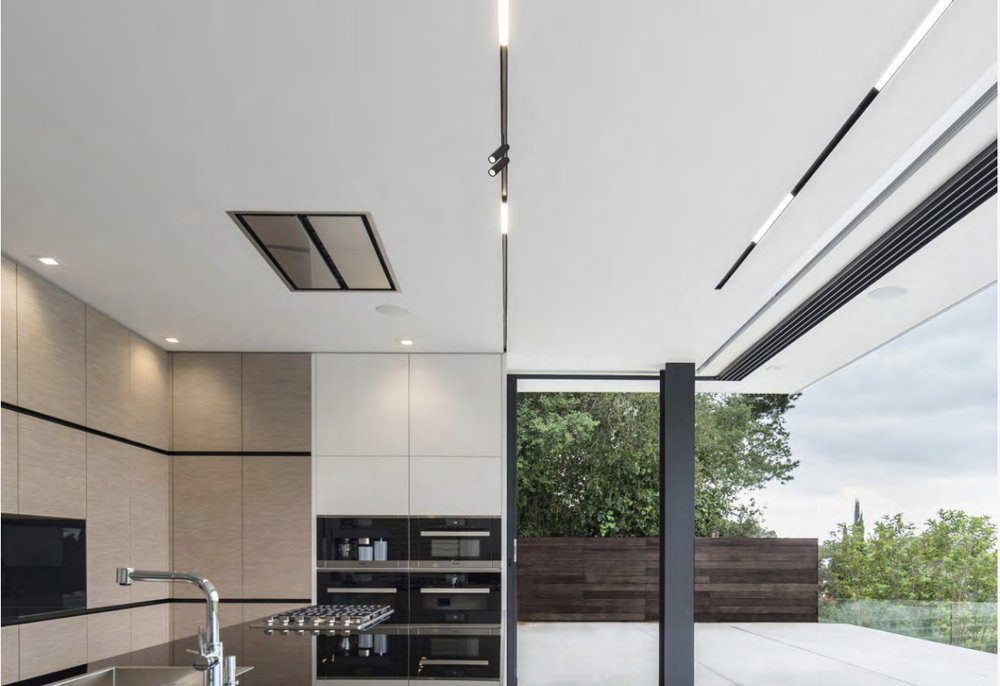 Magnetic track lighting spanning an open kitchen ceiling
