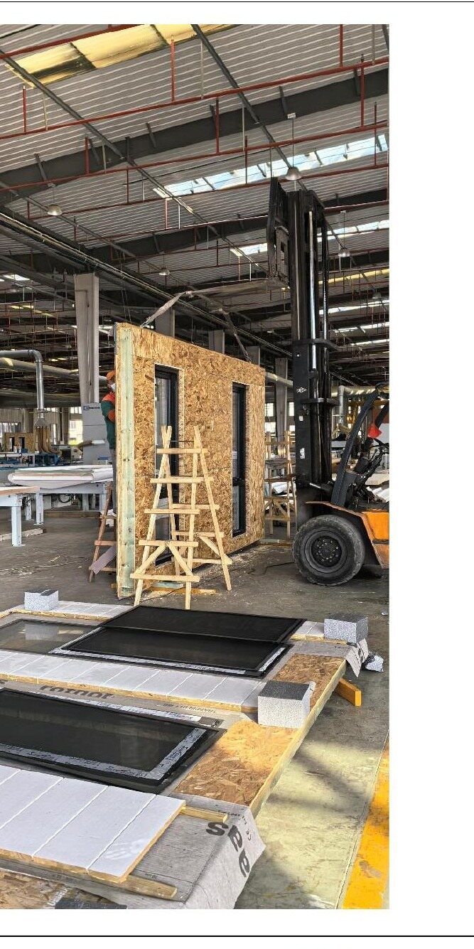 Wall panel with window openings being moved on the factory floor