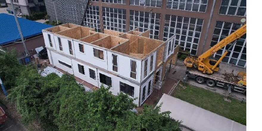 Aerial view of a panelized building under assembly on site